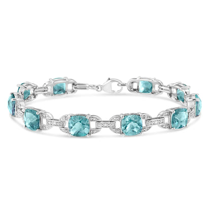 Gioielli - Bracciale tennis alla moda in argento sterling .925 con topazio blu taglio cuscino da 7x7 mm e diamante taglio rotondo da 1/20 cttw (colore IJ, purezza I1-I2) - 7"