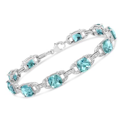 Gioielli - Bracciale tennis alla moda in argento sterling .925 con topazio blu taglio cuscino da 7x7 mm e diamante taglio rotondo da 1/20 cttw (colore IJ, purezza I1-I2) - 7"